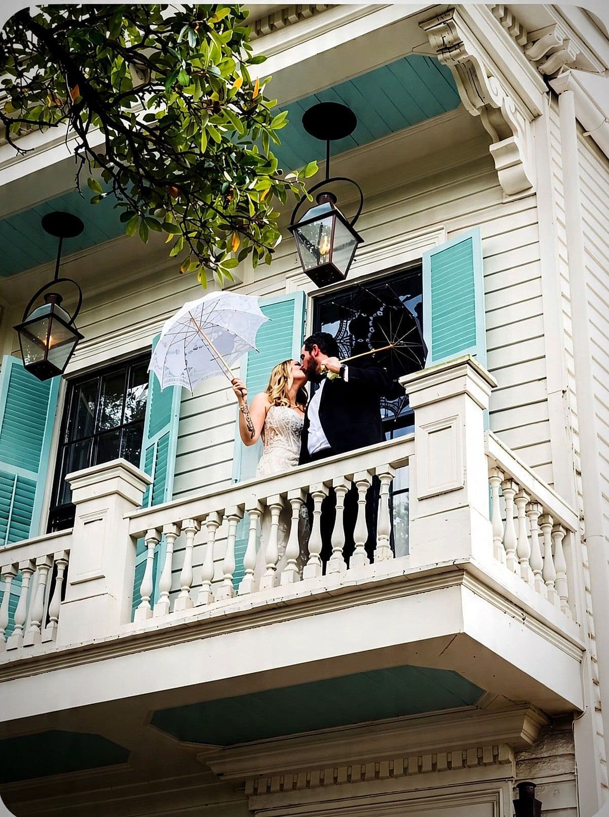 A couple celebrating on the balcony at Maison St. LaFleur