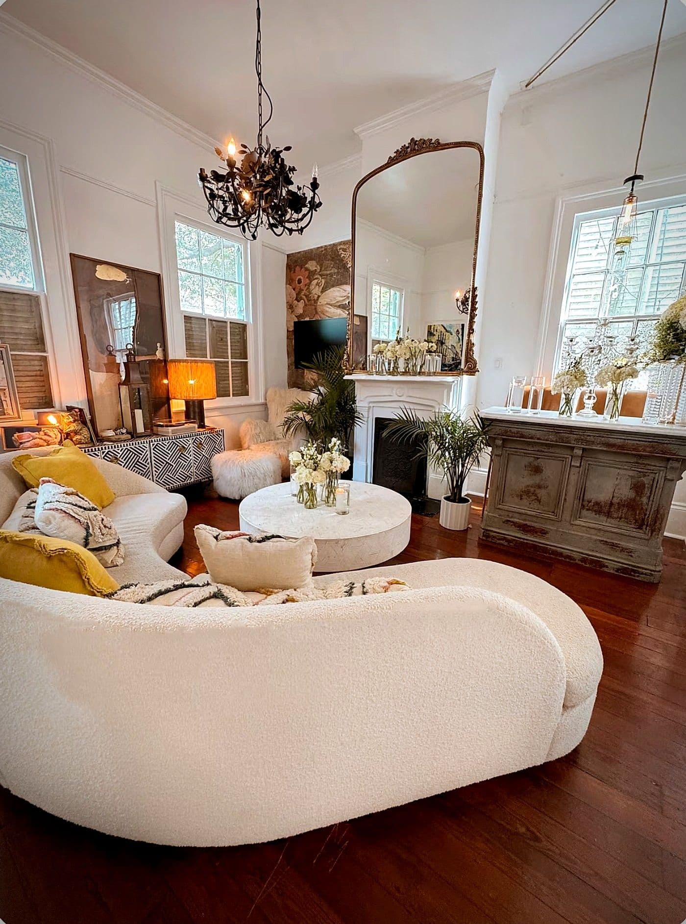 The other side of the double parlor, with cream boucle seating