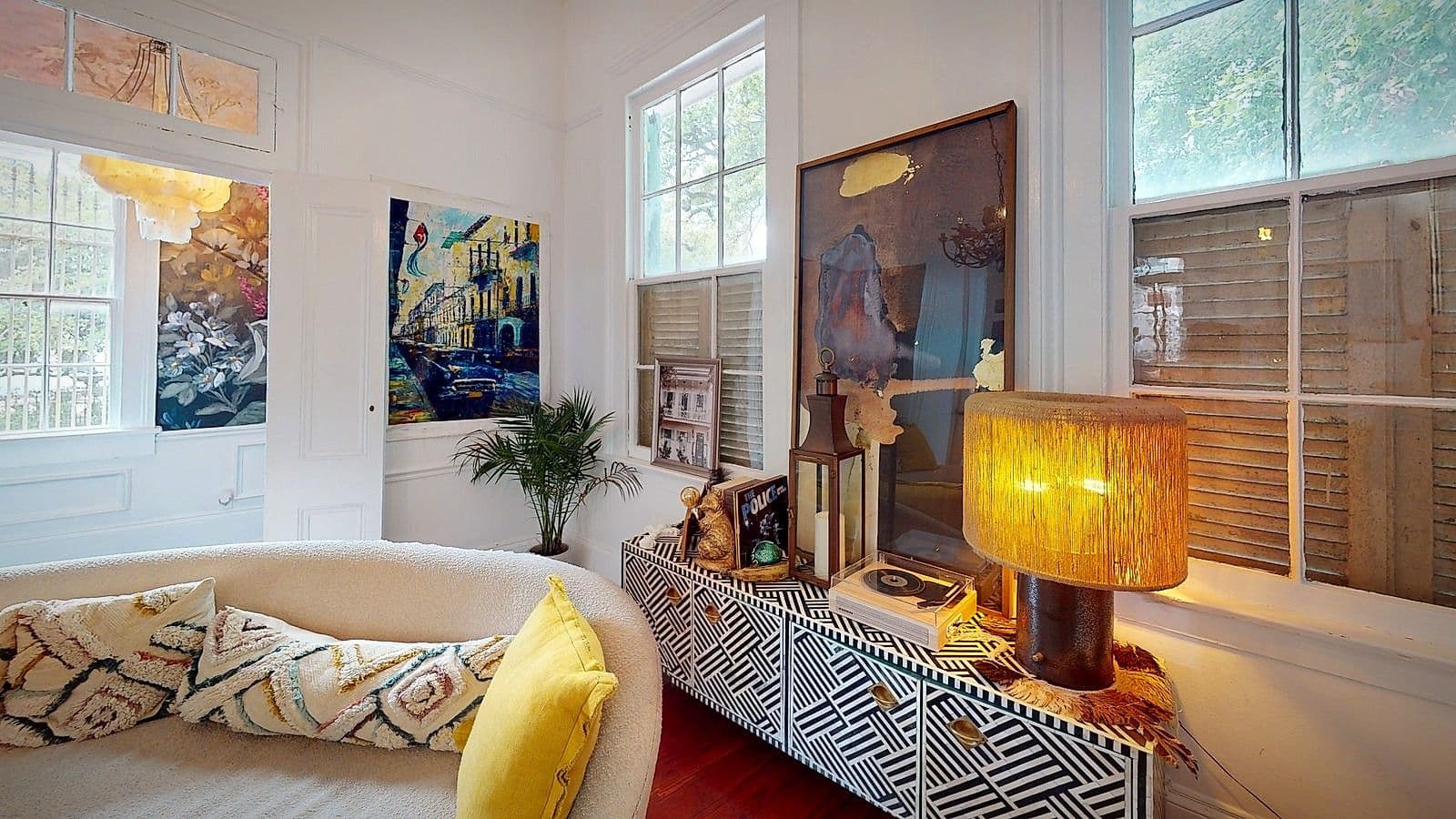 A reading nook with a gallery wall and record player